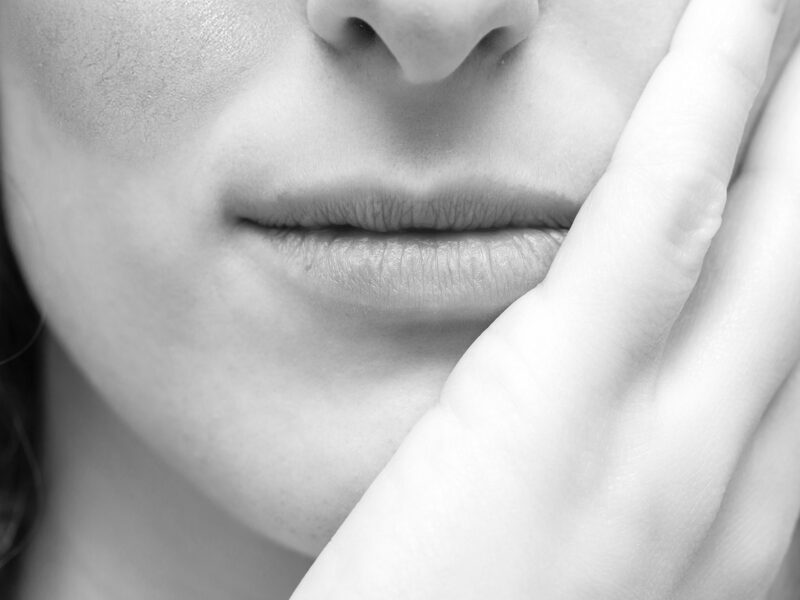 A close up view on a caucasian woman resting her chin on hand, w